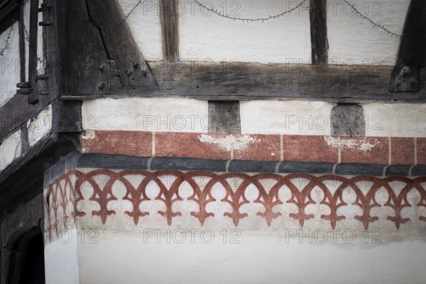 Reddish, painted decorative elements on an old half-timbered house, Blaubeuren Abbey building, Swabian Jura, Baden-Württemberg, Germany
