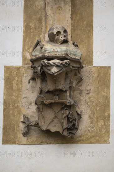 Weathered sculpture with skull, symbolizing transience in an ancient, Gothic style, Blaubeuren, Swabian Jura, Baden-Württemberg, Germany