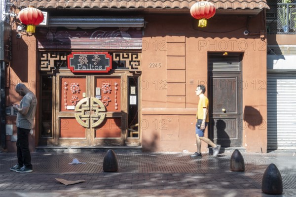 Tourists stroll in Chinatown in front of a Chinese restaurant, Buenos Aires, Argentina