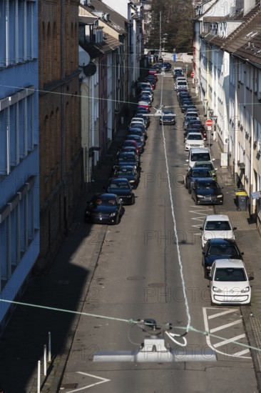 View from above of a street with parked cars and residential buildings with apartment buildings in Wuppertal, Germany