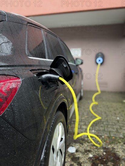 An e-car is charged at a wallbox, Wuppertal, Germany