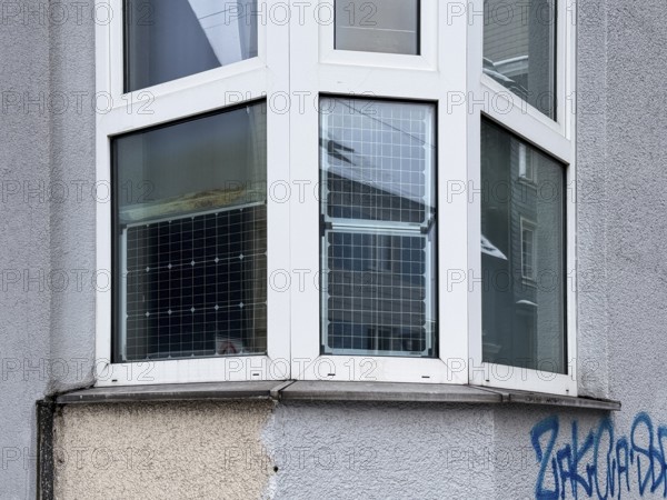 Window front, bay window with solar panels used, sustainable and unusual energy generation in residential buildings, Wuppertal, Germany