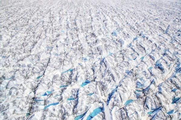 Aerial view of meltwater on the Greenland ice sheet, Arctic landscape, frozen wilderness, glaciers and snow-covered terrain, Climate change, Global warming, Greenland, North America