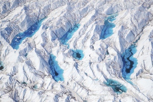 Aerial view of meltwater on the Greenland ice sheet, Arctic landscape, frozen wilderness, glaciers and snow-covered terrain, Climate change, Global warming, Greenland, North America