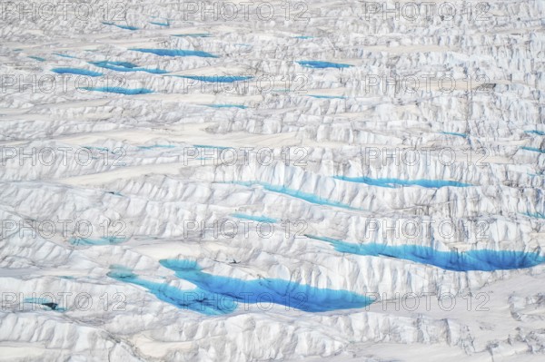 Aerial view of meltwater on the Greenland ice sheet, Arctic landscape, frozen wilderness, glaciers and snow-covered terrain, Climate change, Global warming, Greenland, North America