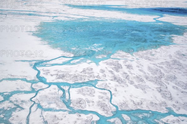 Aerial view of surface lakes (glacial/proglacial lakes) and Glacial rivers, climate change, global warming, Arctic landscape with glaciers and snow-covered terrain, frozen wilderness, climate change, global warming, Greenland, geographically in North America, politically part of the Kingdom of Denmark
