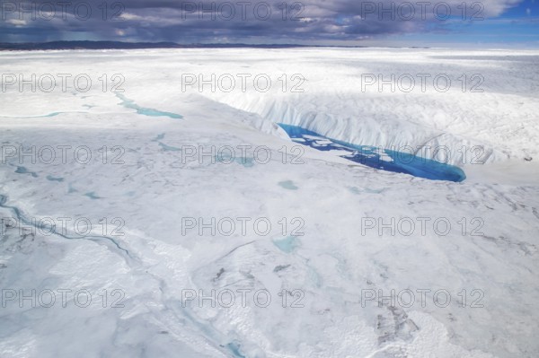 Aerial view of surface lakes (glacial/proglacial lakes), climate change, global warming, Arctic landscape with glaciers and snow-covered terrain, frozen wilderness, climate change, global warming, Greenland, geographically in North America, politically part of the Kingdom of Denmark
