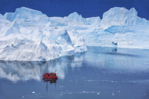 Aerial view of a tourist ship navigating through the fjord among icebergs calved from the Jakobshavn Isbræ (Sermeq Kujalleq) glacier in Disko Bay, the Ilulissat Icefjord, a UNESCO World Heritage Site, Ilulissat, West Greenland (Kalaallit Nunaat), geographically North America, politically part of the Kingdom of Denmark