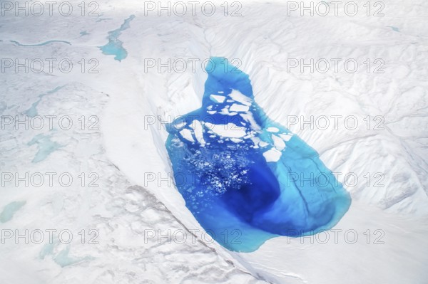 Aerial view of surface lakes (glacial/proglacial lakes), climate change, global warming, Arctic landscape with glaciers and snow-covered terrain, frozen wilderness, climate change, global warming, Greenland, geographically in North America, politically part of the Kingdom of Denmark
