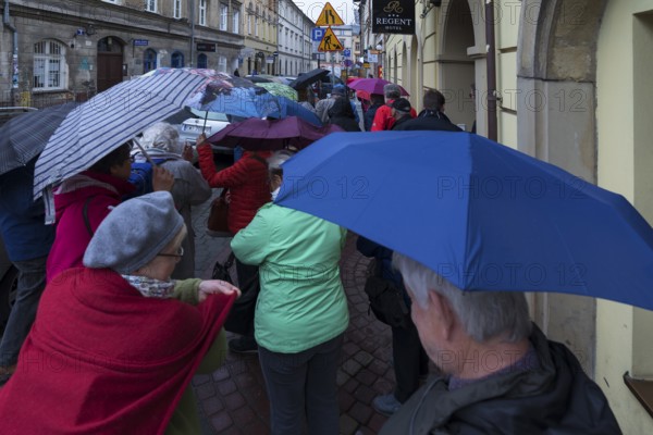 Tourists with umbrellas in Krakow, Poland