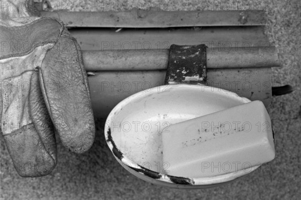 Core soap in a bowl in front of the cowshed on a farm in front of the stable, black and white, Middle Franconia, Bavaria, Germany
