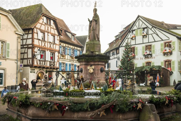 Christmassy decorated houses and fountains with half-timbered houses, Christmas market, Eguisheim, Haut-Rhin department, Grand Est region, Alsace, France