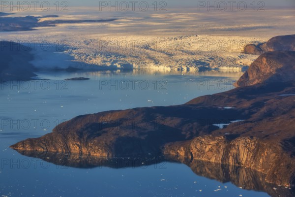 Aerial view of coast and Greenland ice sheet, Arctic landscape, frozen wilderness, glaciers and snow-covered terrain, Climate change, Global warming, Greenland, North America