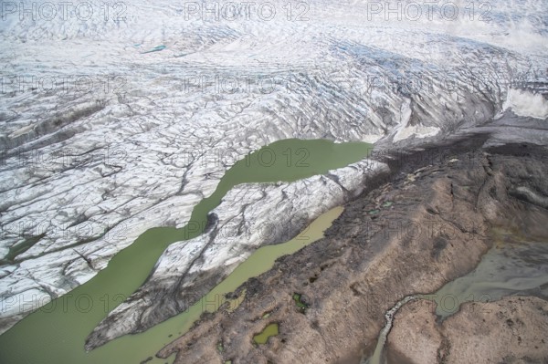 Aerial view of coast and Greenland ice sheet, Arctic landscape, frozen wilderness, glaciers and snow-covered terrain, Climate change, Global warming, Greenland, North America