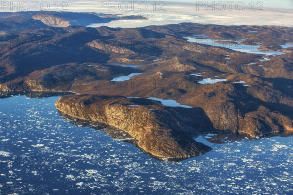 Aerial view of the coast and Greenland ice sheet, Arctic landscape, frozen wilderness, glaciers and snow-covered terrain, Climate change, Global warming, Greenland, North America
