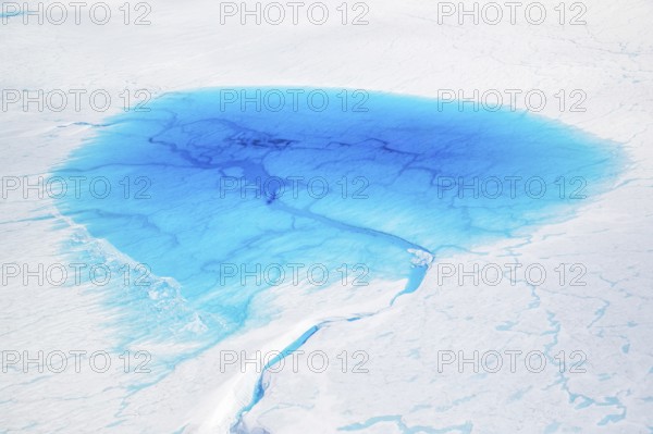 Aerial view of surface lakes (glacial/proglacial lakes) and Glacial rivers, climate change, global warming, Arctic landscape with glaciers and snow-covered terrain, frozen wilderness, climate change, global warming, Greenland, geographically in North America, politically part of the Kingdom of Denmark