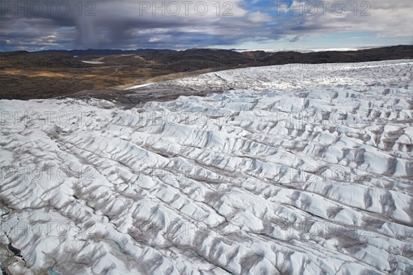 Aerial view and coast and Greenland ice sheet, Arctic landscape, frozen wilderness, glaciers and snow-covered terrain, Climate change, Global warming, Greenland, North America