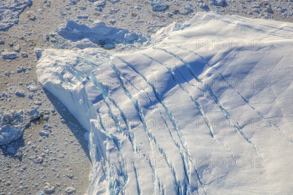 Aerial view of a big iceberg, Arctic landscape, frozen wilderness, glaciers and snow-covered terrain, Climate change, Global warming, Greenland, North America