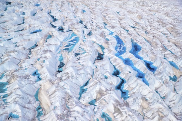 Aerial view of meltwater on the Greenland ice sheet, Arctic landscape, frozen wilderness, glaciers and snow-covered terrain, Climate change, Global warming, Greenland, North America