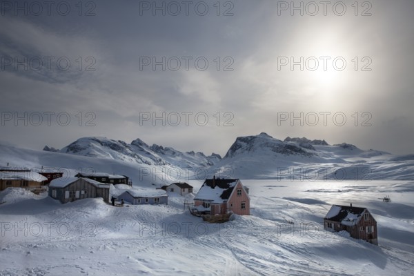 Tiniteqilaaq covered in snow during winter. The village is one of five settlements around Ammassalik Island, located in the Sermersooq municipality on Ikasativaq Fjord, north of Ammassalik Island and facing Sermilik, Greenland, North America