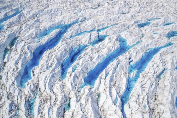 Aerial view of meltwater on the Greenland ice sheet, Arctic landscape, frozen wilderness, glaciers and snow-covered terrain, Climate change, Global warming, Greenland, North America