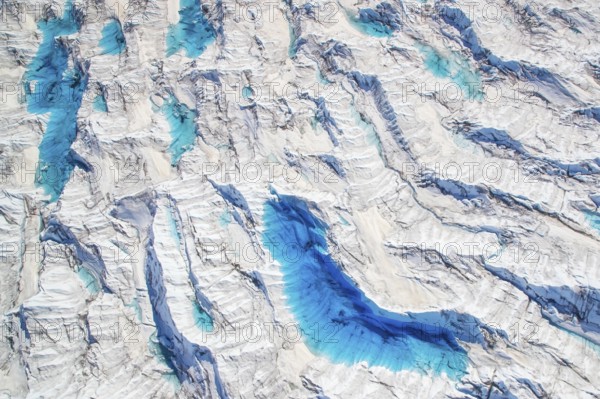 Aerial view of meltwater on the Greenland ice sheet, Arctic landscape, frozen wilderness, glaciers and snow-covered terrain, Climate change, Global warming, Greenland, North America