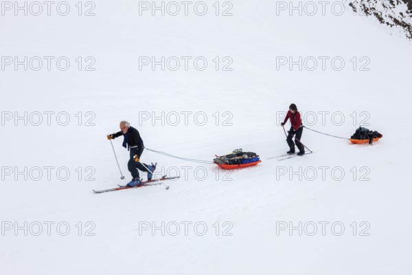 Tourists on a winter Arctic expedition skiing along Ikasartivaq Fjord, Sermersooq municipality, north of Ammassalik Island and facing Sermilik, Greenland, North America