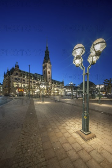 Hamburg City Hall with illuminated blue hour façade and street lamp in the foreground, Hamburg, Germany