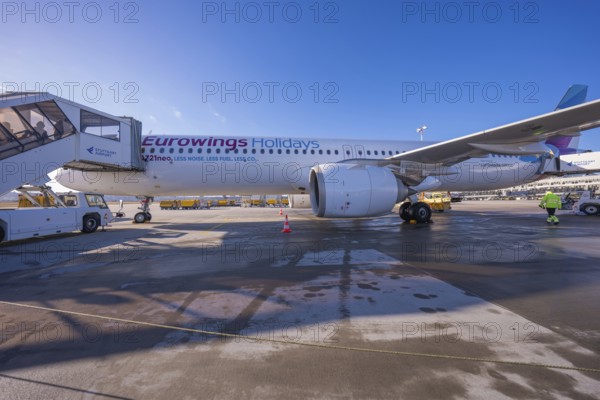 Eurowings aircraft on the ground with mobile stairs and clear blue sky in the background, Stuttgart Airport, Germany