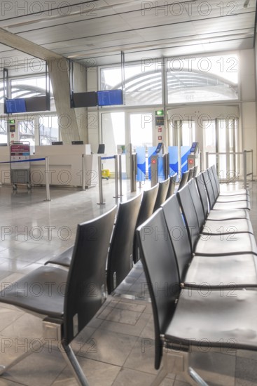 Empty waiting area at the airport with modern rows of seats and light-filled surroundings, Stuttgart Airport, Germany