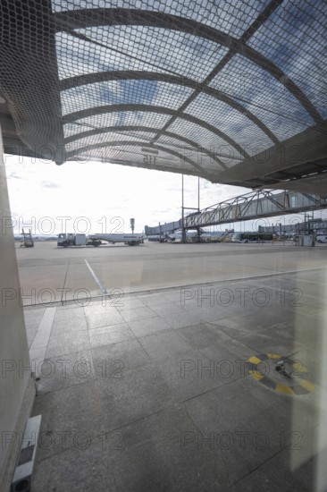 Apron covered by a grid construction with far-reaching views and sunlight, Stuttgart Airport, Germany