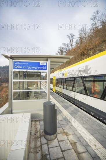 A train station in Calw in the Black Forest with a train and wooded landscape in the background, taking off the Hermann Hessebahn, Calw, Germany