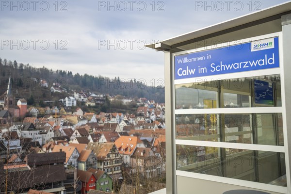 A Calw sign with a picturesque view of a village in the Black Forest, taking off the Hermann Hessebahn, Calw, Germany