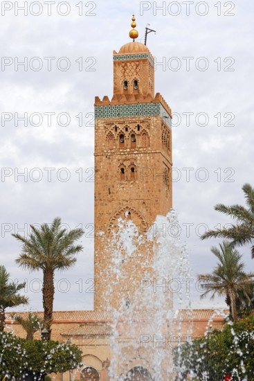 Minaret of the Koutoubia Mosque with water fountain from a fountain, landmark of Marrakech, historic old town, medina, UNESCO World Heritage Site, Morocco