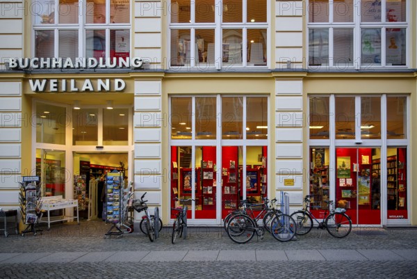 Weiland bookstore with bicycles parked in front of it, at the fish market in the Hanseatic City of Greifswald, Mecklenburg-Western Pomerania, Germany, for editorial use only