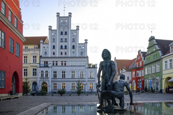 Fishing fountain with sculptures by Jo Jastram at the fish market in the Hanseatic city of Greifswald, Mecklenburg-Western Pomerania, Germany, for editorial use only