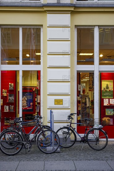 Bicycles parked in front of the Weiland bookstore at the fish market in the Hanseatic City of Greifswald, Mecklenburg-Western Pomerania, Germany, for editorial use only