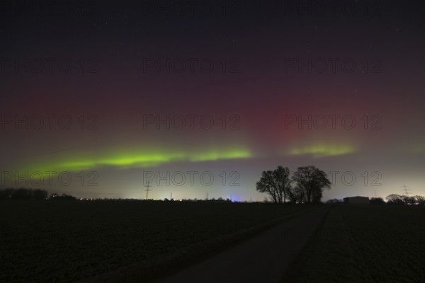 Northern lights (aurora borealis) glow red and green in the evening sky over Germany, Frankfurt am Main, Hesse, Germany