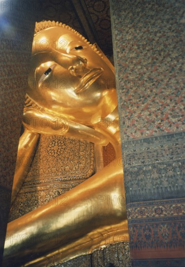 Reclining Buddha in Wat Po. The reclining Buddha symbolizes the last earthly hours in front of entering Nirvana. This state is called Paranirvana, a state reserved only for enlightened beings at the end of their lives. Buddha, Buddhism, religion, Bangkok, Thailand, Southeast Asia