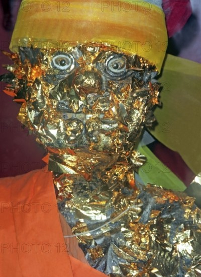 Statue of a monk in a Buddhist temple decorated with gold plates. Buddha, Buddhism, religion, Phuket, Thailand, Southeast Asia