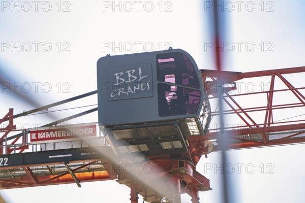 Side view of a construction crane with focus on the crane operator cabin and structures, carpentry, new building, Stuttgart, Germany