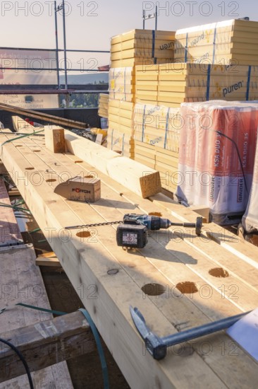Building materials such as wood and tools on a construction site in the sun, carpentry, new building, Stuttgart, Germany