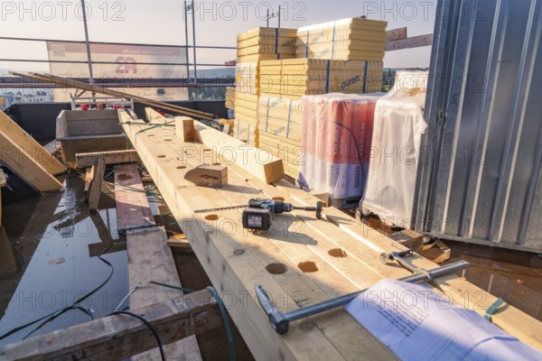 Construction site with wood and tools. Stack of building materials in bright sunlight, carpentry, new building, Stuttgart, Germany