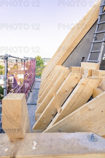 Timber structure of a roof with a view of scaffolding in daylight, carpentry, new building, Stuttgart, Germany