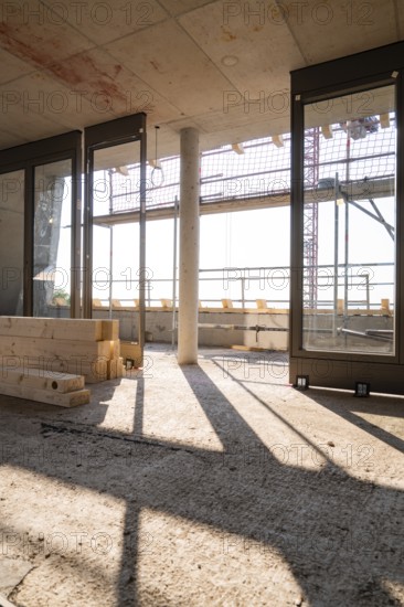 Interior view of a shell with large windows and incoming sunlight, carpentry, new building, Stuttgart, Germany