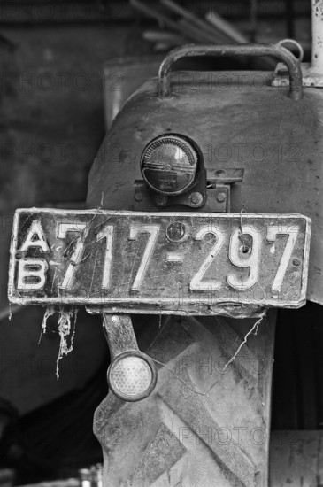 Old tractor license plate from the 1950s, on a former Franconian farm, black and white, Bavaria, Germany