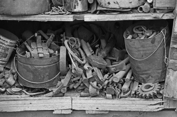 Collection of tools in an old cupboard in the courtyard, on a former Franconian farm, black and white, Bavaria, Germany