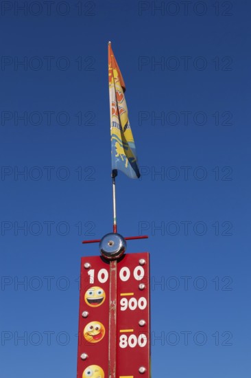Close-up of High Striker game of strength with numbered score levels at Fun Show traveling amusement ride park, Old Port of Montreal, Quebec, Canada