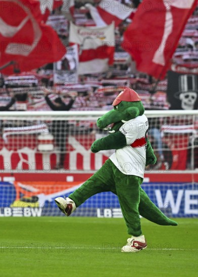 Mascot Fritzle VfB Stuttgart kicks in front of fan block, fans, fan curve, flags, atmosphere, atmospheric Cannstatt curve VfB Stuttgart, MHPArena, MHP Arena Stuttgart, Baden-Württemberg, Germany