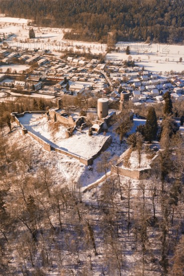 Medieval castle ruins on a wooded hill in a snowy village, Nagold, Calw district, Black Forest, Germany